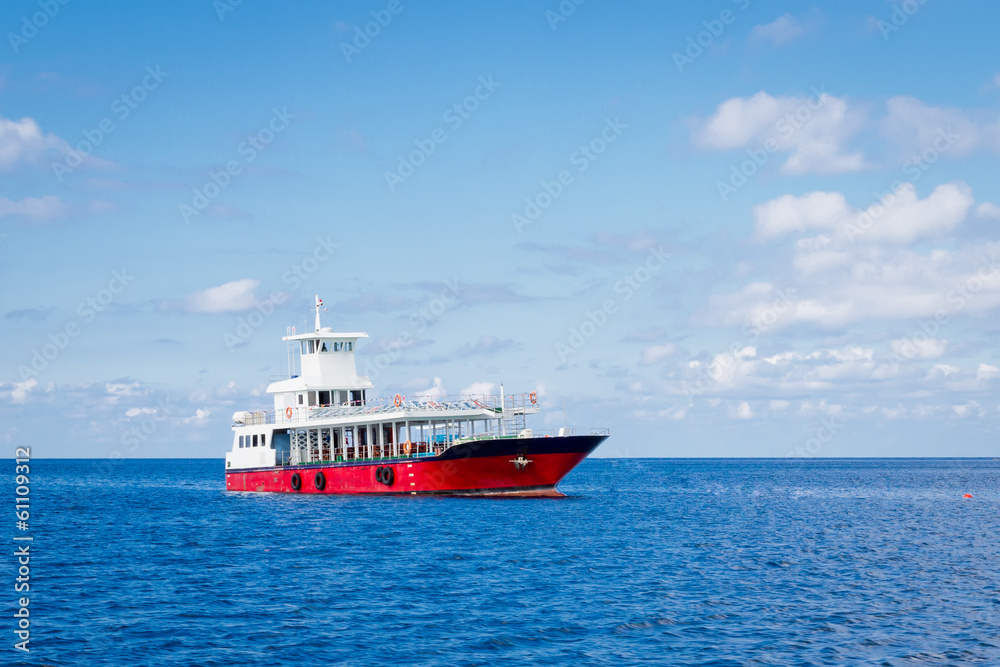 Passenger ferry boat in open waters over against blue sky Passenger ferry boat in open waters over against blue sky