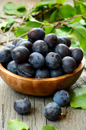 Plums in wooden bowl