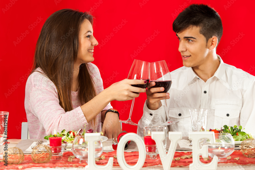 Young couple celebrating valentine's over dinner. Young couple celebrating valentine's over dinner.