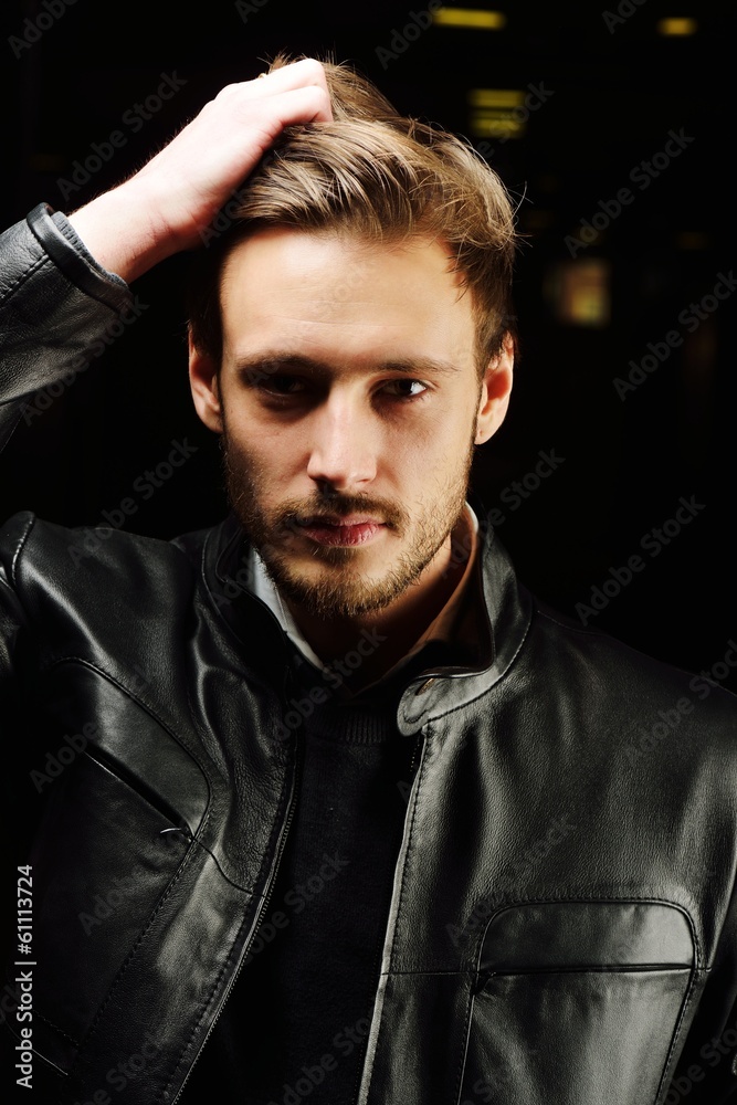 Fashionable young man with leather clothes on Fashionable young man with leather clothes on