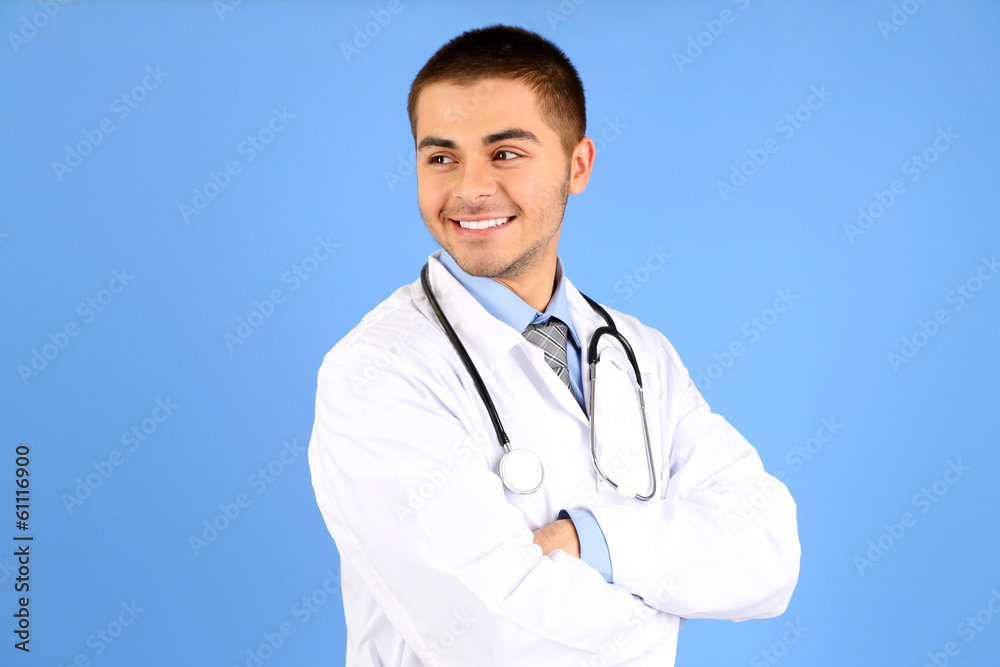 Male Doctor standing with folder, on blue background Male Doctor standing with folder, on blue background