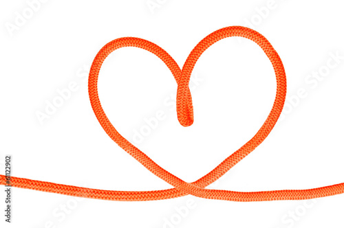 Heart shaped red knot on a jute rope isolated on white backgroun
