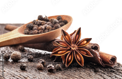 Fototapeta Different spices, Cinnamon, anise on wooden old table