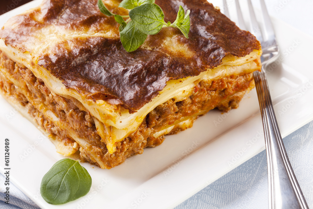 Portion of tasty lasagna on a plate Portion of tasty lasagna on a plate