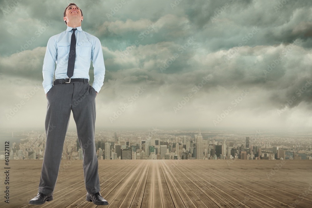 Composite image of happy businessman standing with hands in pock Composite image of happy businessman standing with hands in pock
