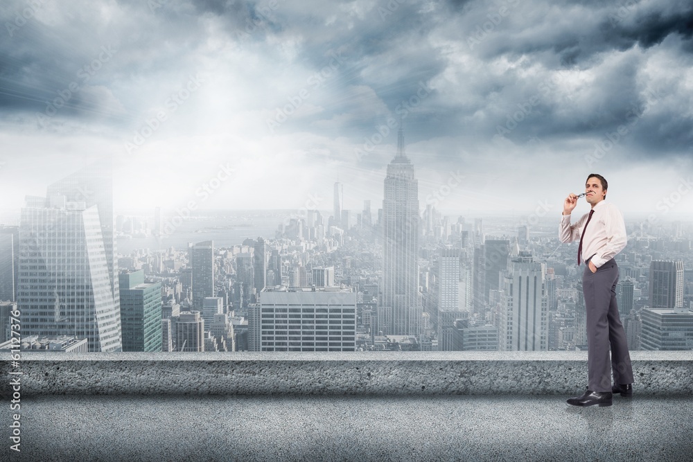 Composite image of thinking businessman holding glasses Composite image of thinking businessman holding glasses