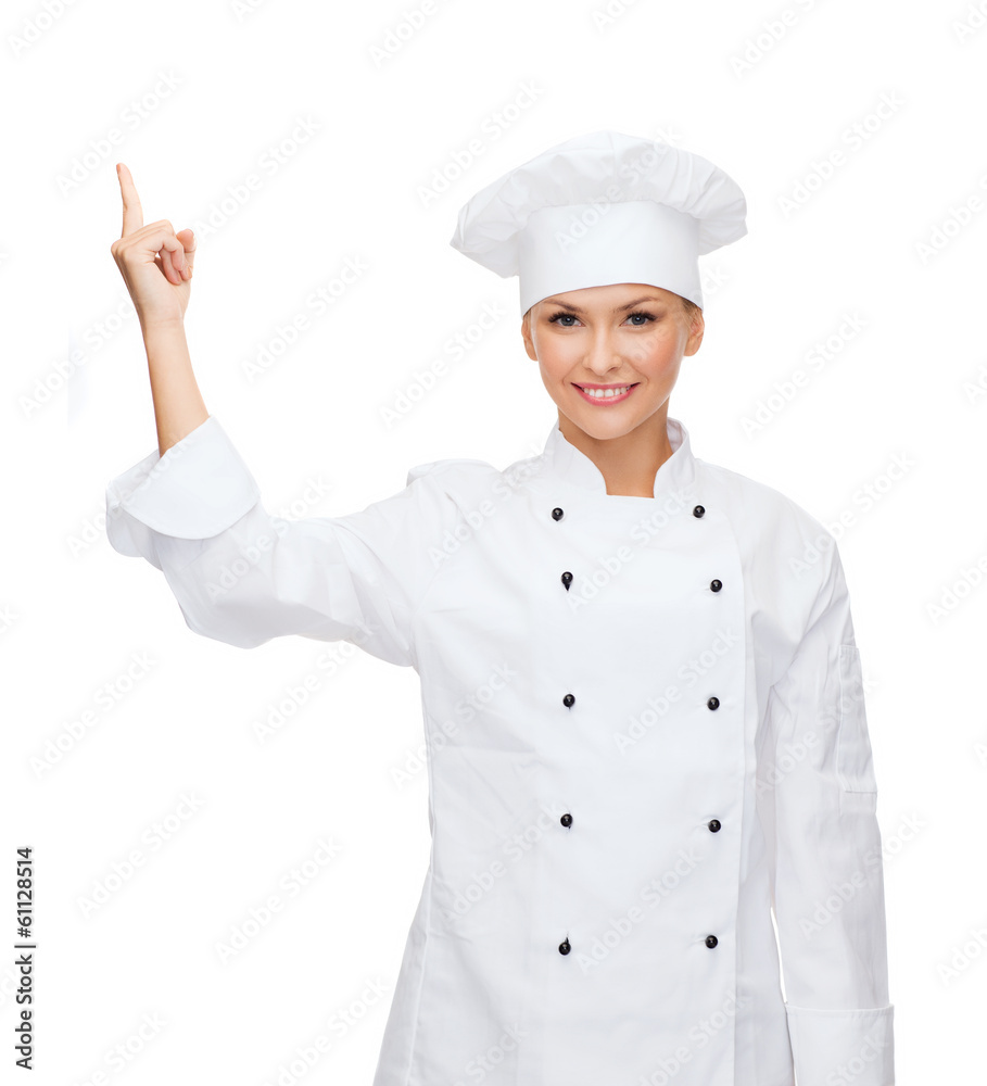 smiling female chef pointing finger to sonething smiling female chef pointing finger to sonething