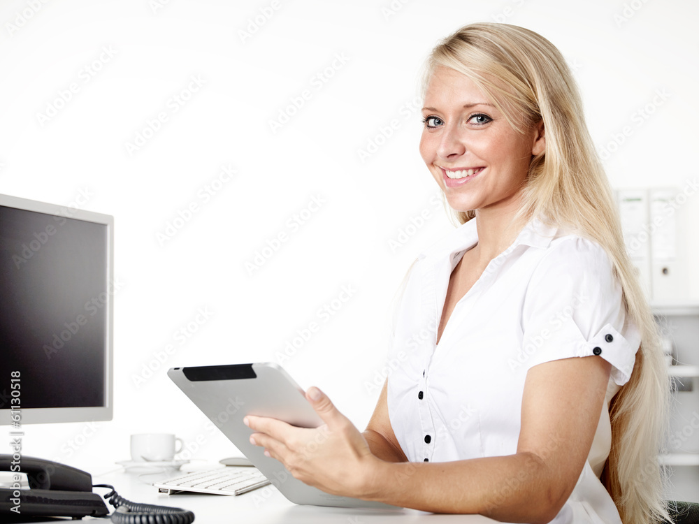 Female office assistant works with tablet at the office Female office assistant works with tablet at the office