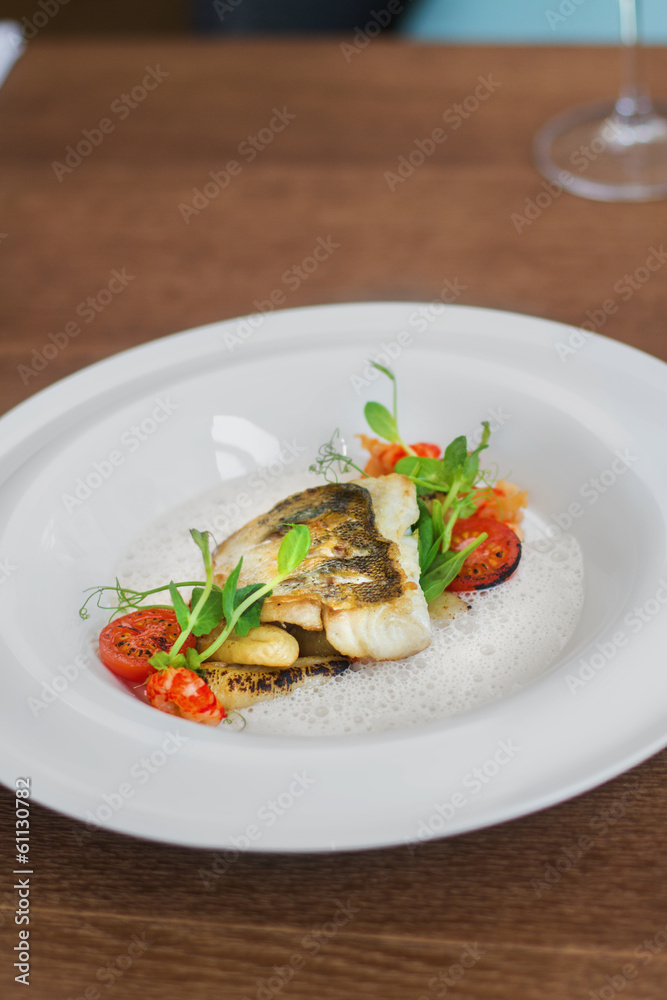 Close image of fish on dish with shrimps in restaurant Close image of fish on dish with shrimps in restaurant