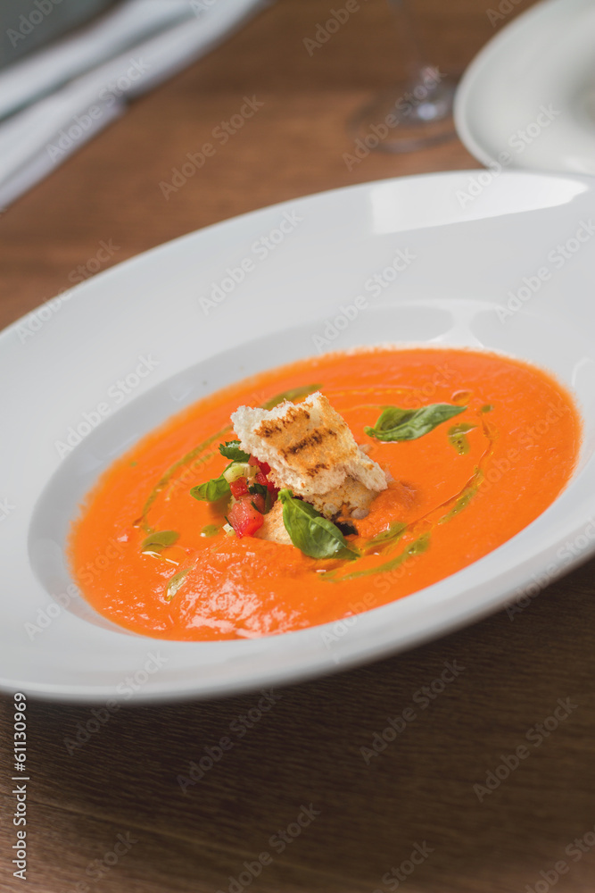 Image of tasty pumpkin soup with crouton and basil served in res Image of tasty pumpkin soup with crouton and basil served in res