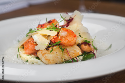 Image of tasty salad with shrimps and cheese in restaurant