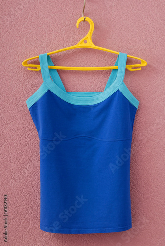 sports tee shirt is on yellow clothes-hanger