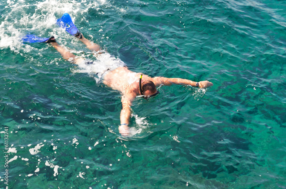 Man snorkeling in tropics