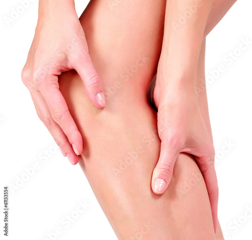 Woman holding sore knee  on white background