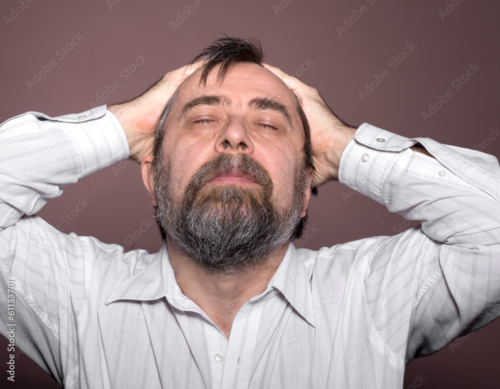 Elderly man suffering from a headache Elderly man suffering from a headache