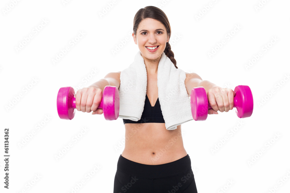 Trainer holding dumbbells in her outstretched arms Trainer holding dumbbells in her outstretched arms