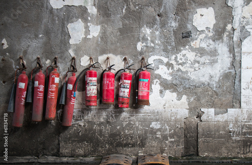 Old exinguisher on grunge wall, group, background photo