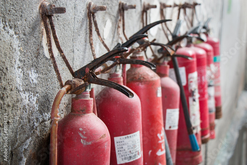 Old exinguisher on grunge wall, group, background