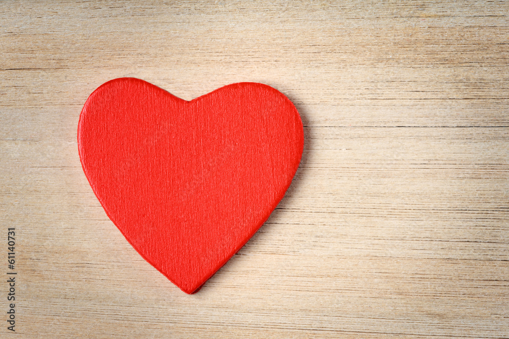 Red heart on book's pages background Red heart on book's pages background