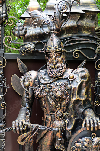 Ornate metal statue of a knight at arms