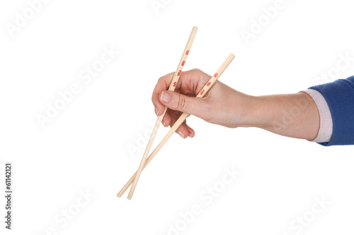 Female hand holding crossed chopsticks