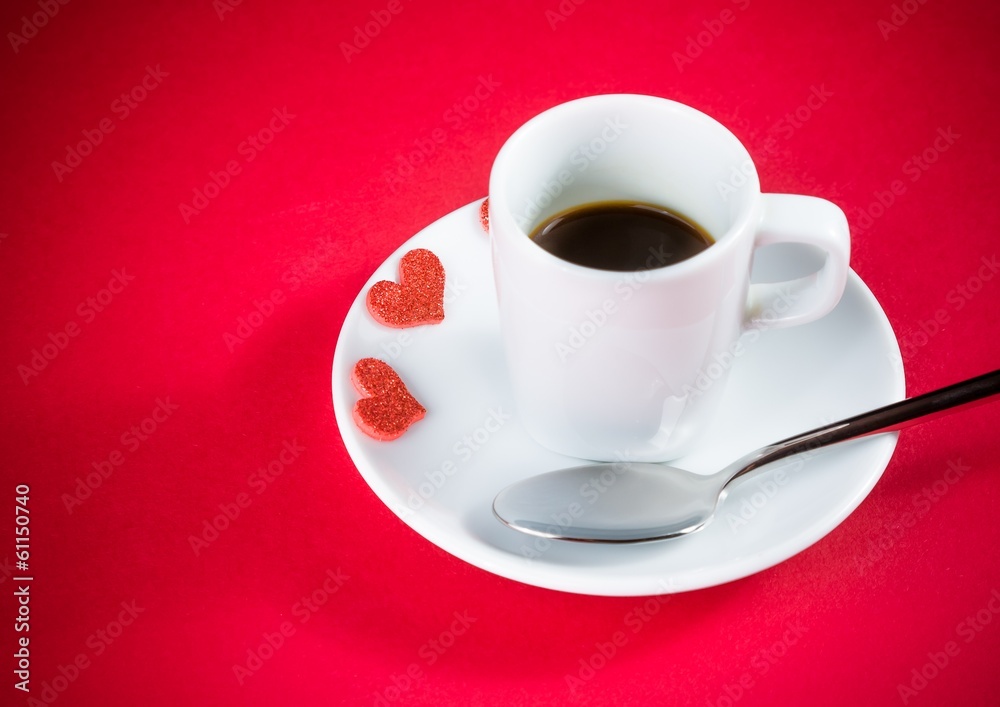 decorative red hearts near cup of coffee on red table decorative red hearts near cup of coffee on red table