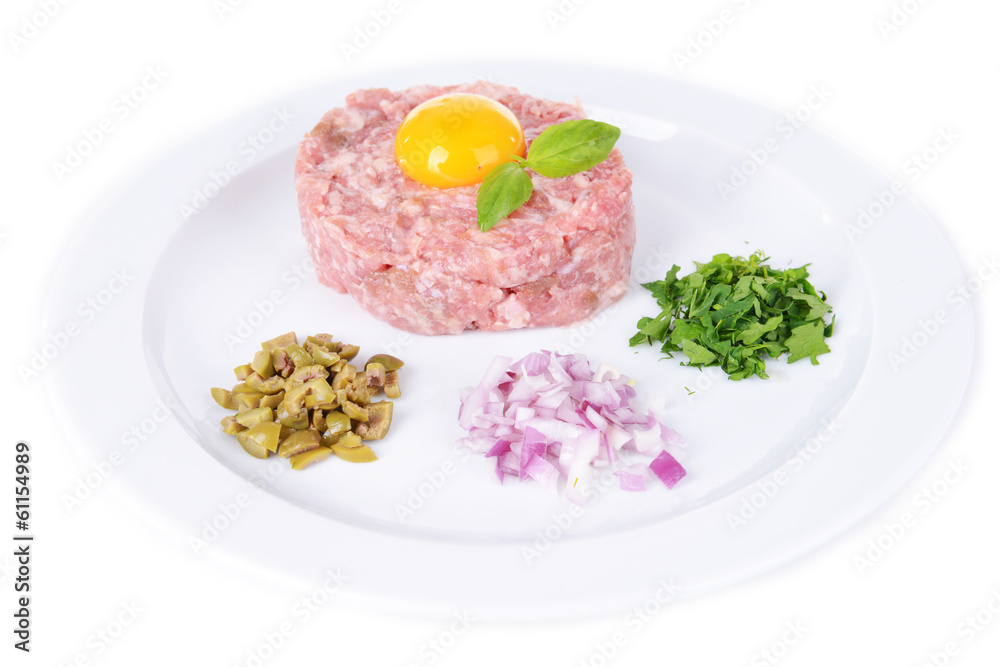 Delicious steak tartare with yolk on plate isolated on white