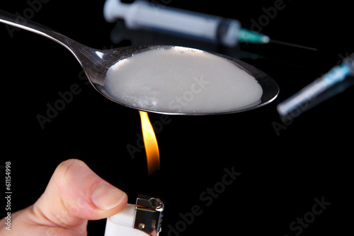 Foto Heroin in spoon on black background