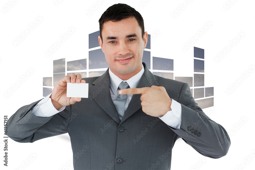 Composite image of businessman pointing at his businesscard Composite image of businessman pointing at his businesscard