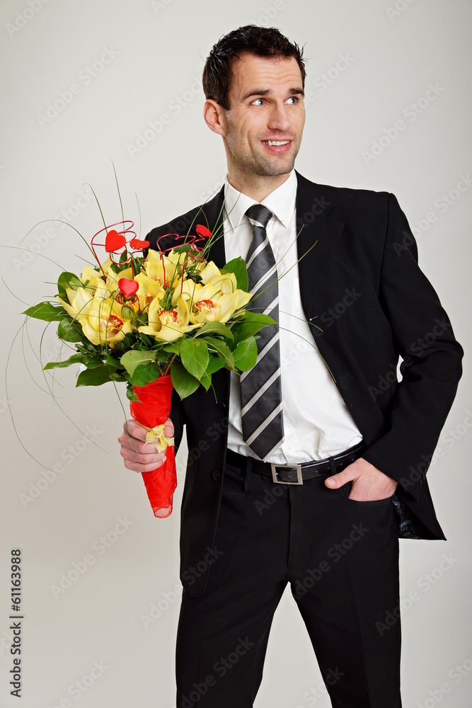 Thoughtful man at suit with bouquet of orchids for Valentine. Thoughtful man at suit with bouquet of orchids for Valentine.