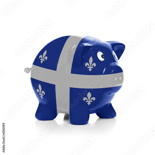 Fototapeta Naklejka Na Ścianę i Meble -  Piggy bank with flag coating over it - Quebec Flag
