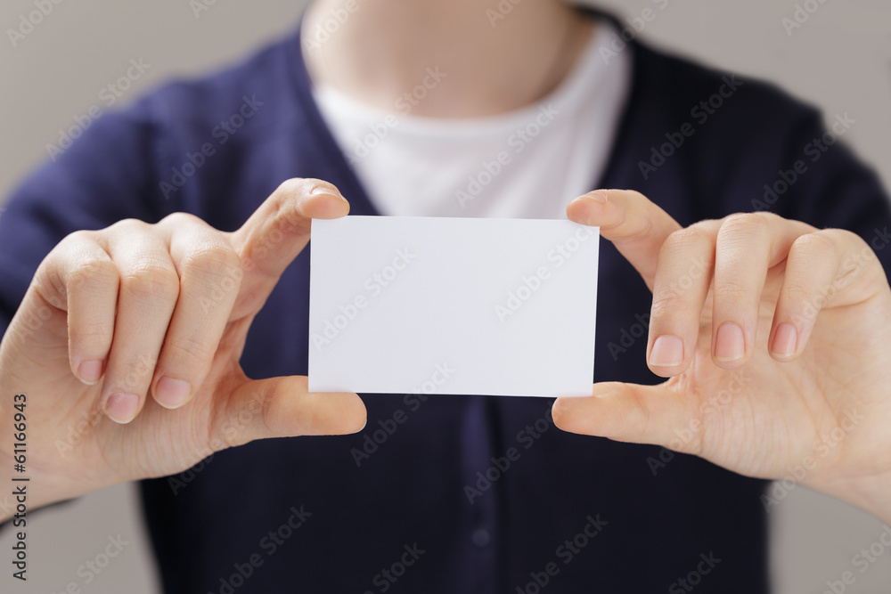 female teen hands holding business card female teen hands holding business card