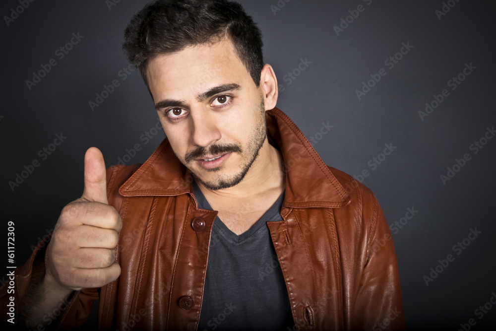 Young man showing thumb up gesture