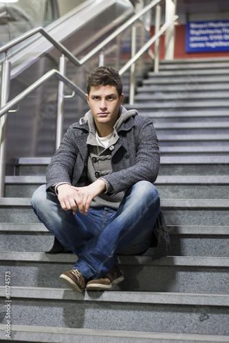 Handsome young man sitting on stairs © theartofphoto