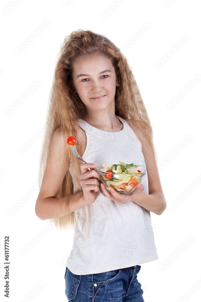 Girl eating vegetable salad, using fork - healthy food concept Girl eating vegetable salad, using fork - healthy food concept