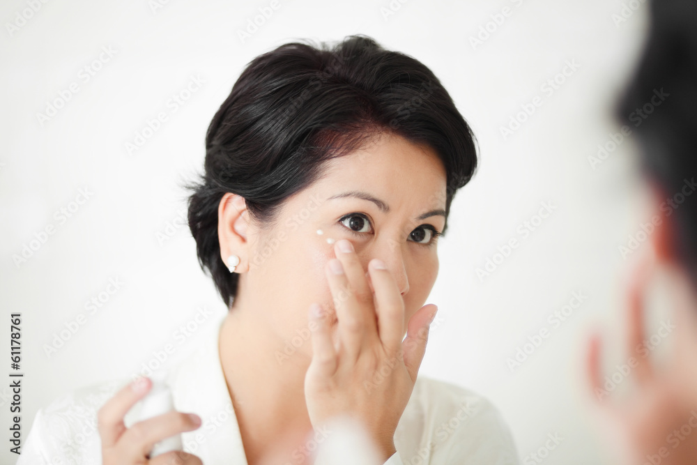 applying facial treatment or cream applying facial treatment or cream