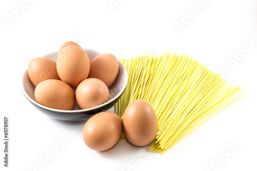 Brown Egg in dish and dry noodle on white background