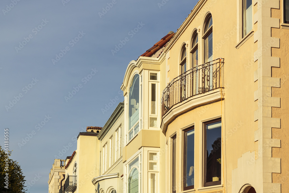A row of upscale houses with roof and cornice detail