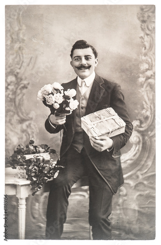 portrait of young man with rose flowers and gift