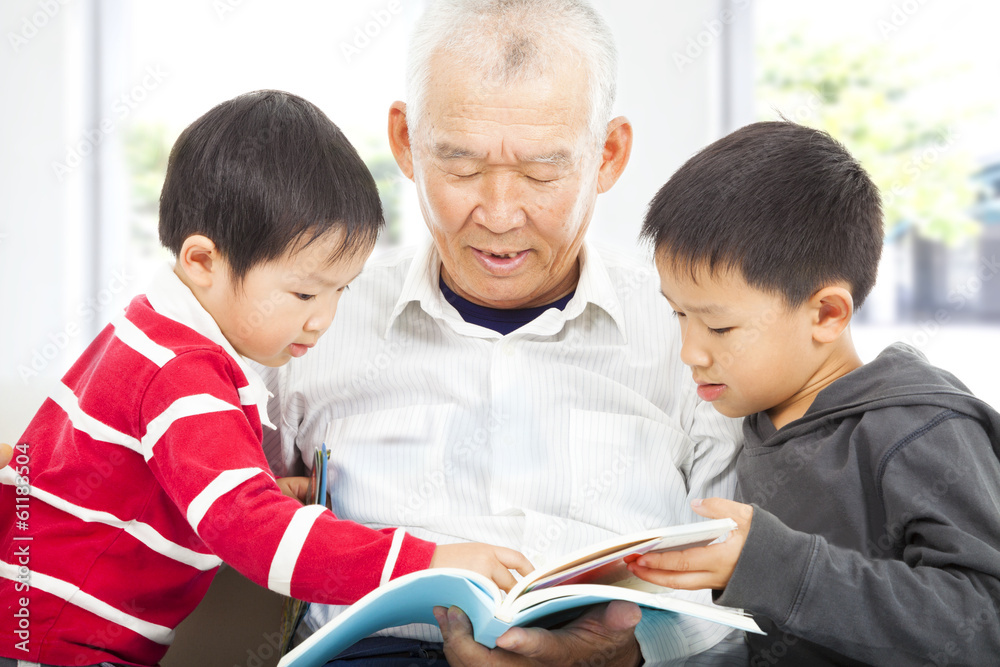 grandfather and grandchildren reading a book grandfather and grandchildren reading a book