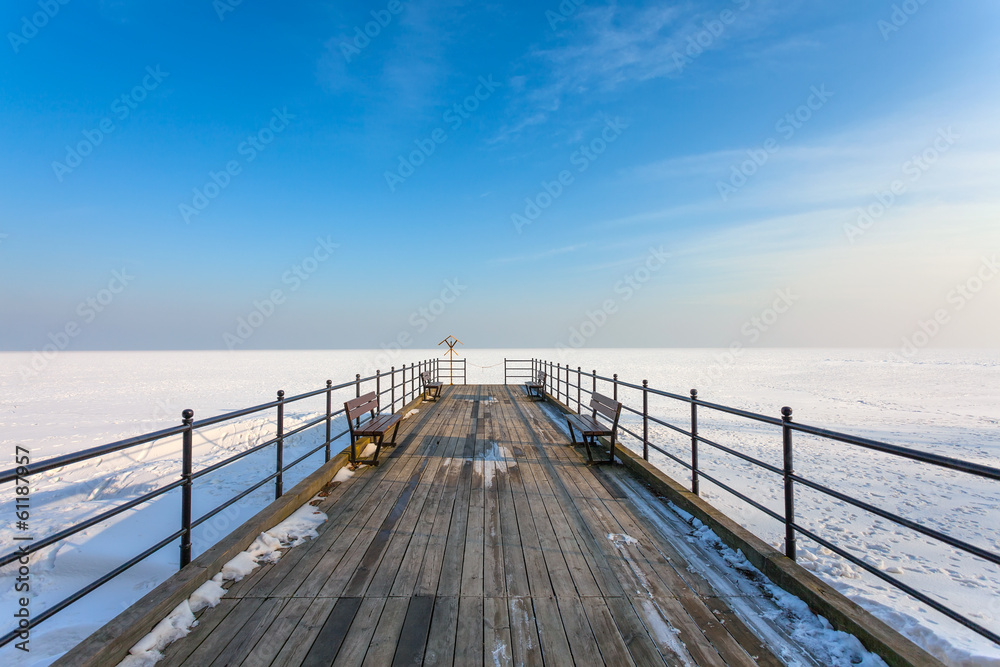 Wooden pier on the frozen sea