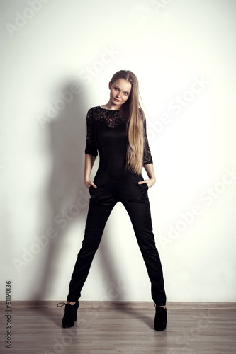 young fashion blonde long legs girl studio posing shoot