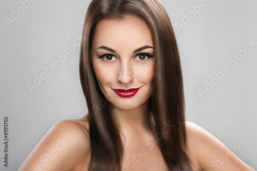 Photo of a beautiful woman with long straight brown hair looking