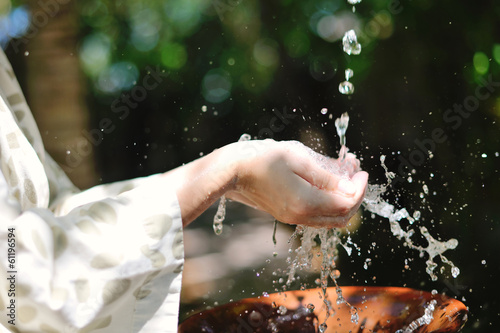 splashing fresh water on woman hands