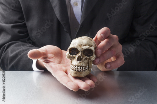 symbol of pychotherapy with skull in hands of professionals