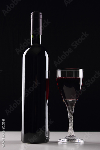 bottle with red wine and glass