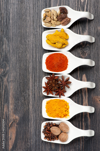 Various colorful spices on a vintage board