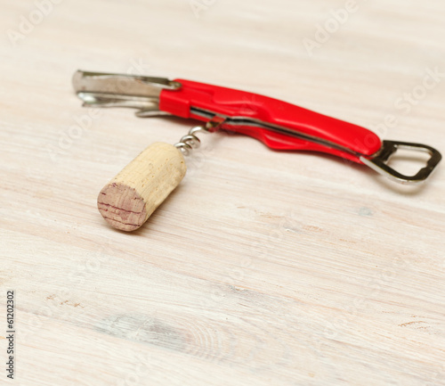 corkscrew with cork from wine on a wooden table