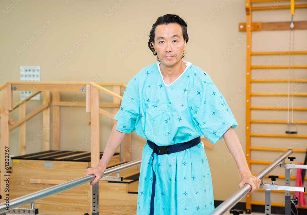 Male Patient Standing With The Support Of Bars Male Patient Standing With The Support Of Bars