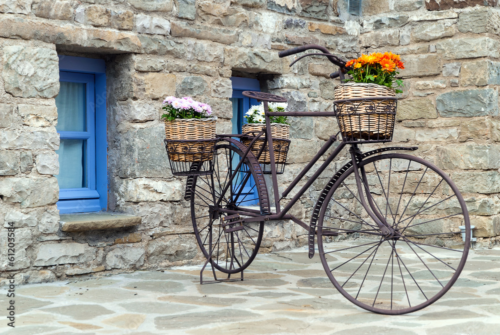 Rusty bicycle in front of a traditional house in Epirus, Greece - obrazy, fototapety, plakaty 